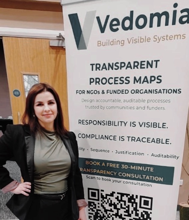 Sandra Ahmidat Fedáková beside the Vedomia Building Visible Systems banner
